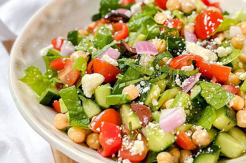 Side closeup view of Mediterranean Chopped Salad in a white bowl.