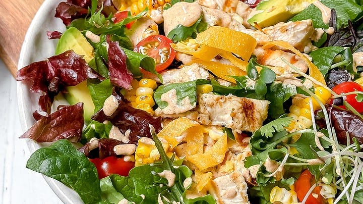 Closeup side view of Southwest Chicken Salad in a white bowl.
