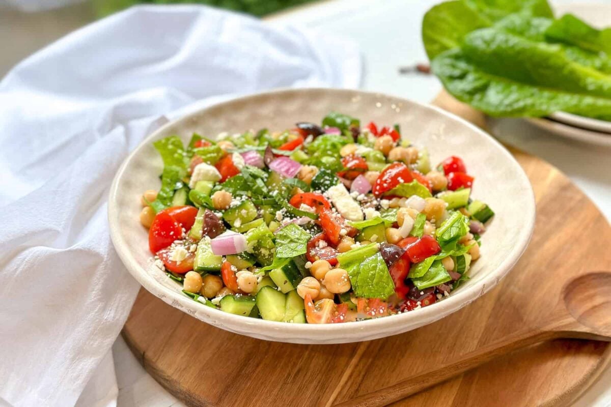 Side view of Mediterranean Chopped Salad in a white salad bowl.