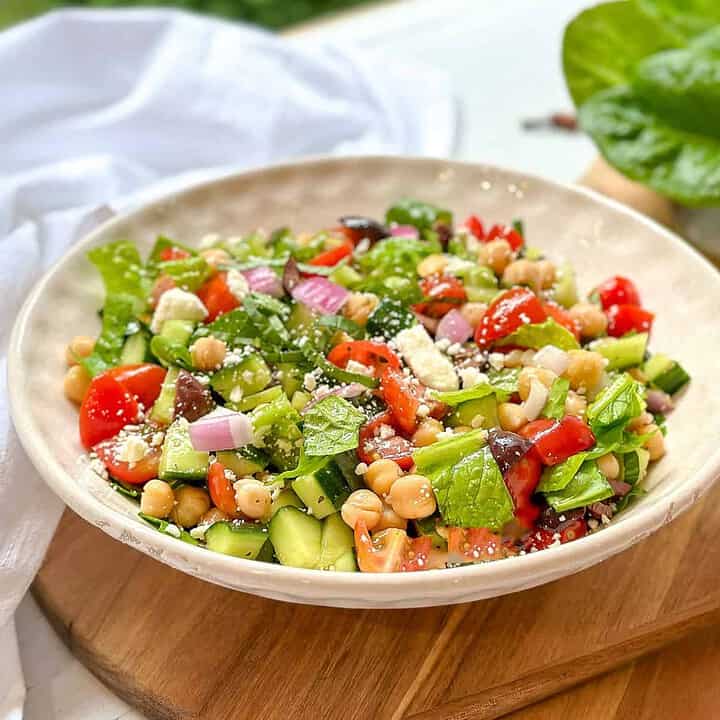 Side view of Mediterranean Chopped Salad in a white salad bowl.