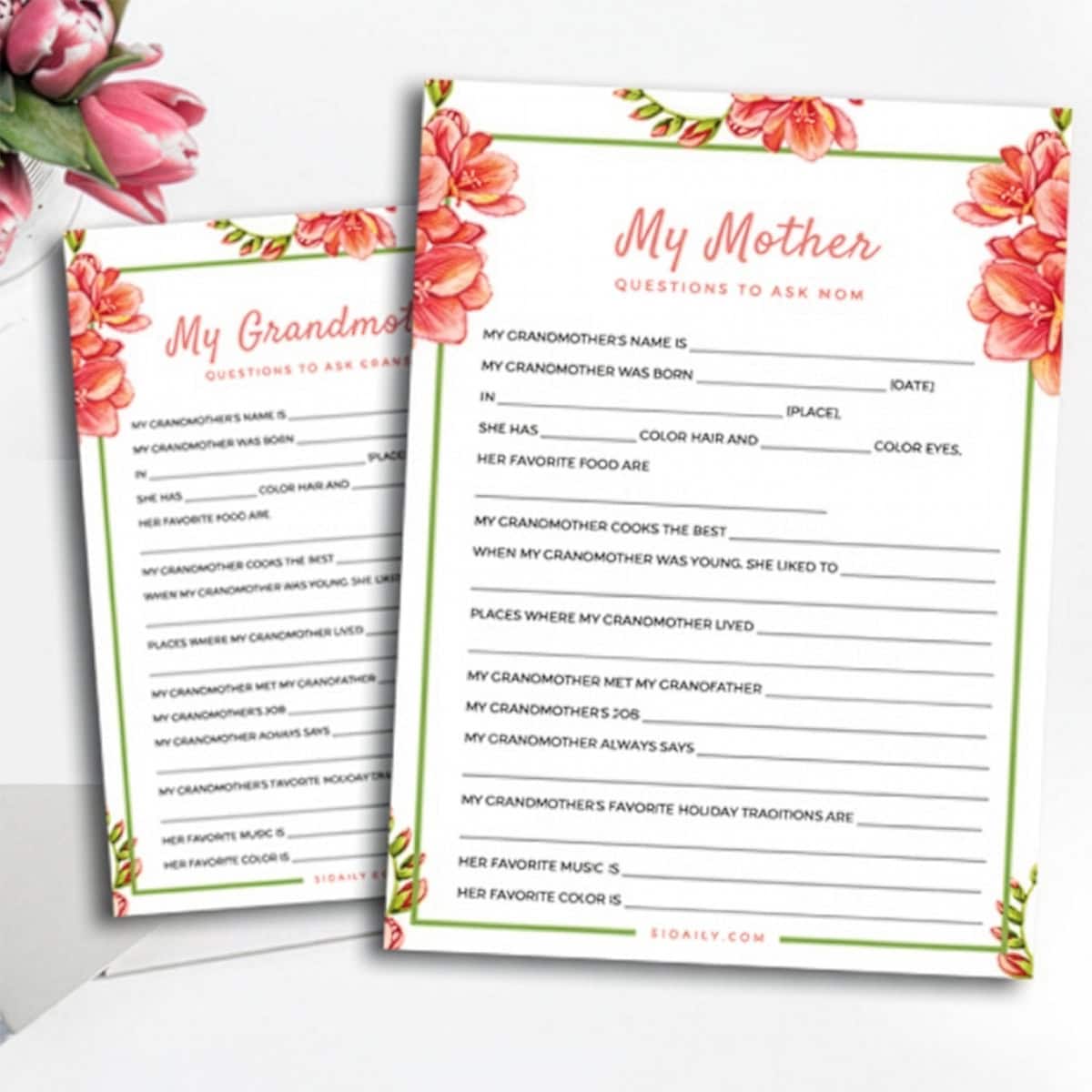 Two floral-themed "My Mother" and "My Grandmother" questionnaires with fill-in-the-blank Mother’s Day Questions about their lives, placed on a white surface with pink tulips nearby.