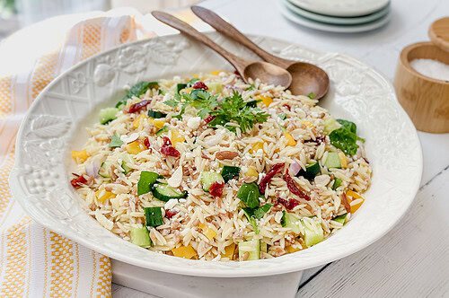 Three-quarter view of farro salad in a white salad bowl for serving.