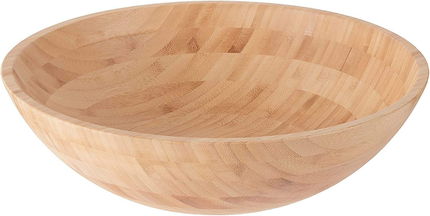 A round, empty wooden bowl with a smooth, light-colored finish, perfect for serving fresh salad recipes, shown against a white background.