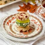 Apple Turkey Tea Sandwich with cranberry bread, slices of apple and herbed goat cheese on a Spode plate for serving afternoon tea.
