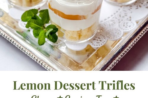 Four luscious lemon dessert trifles, crowned with whipped cream, lemon slices, and mint leaves, rest elegantly on a silver tray. The text overlay reads "Lemon Dessert Trifles: Elegant Spring Treat." Perfect for any dessert trifle enthusiast!.