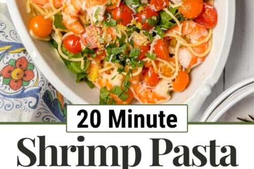 Overhead view of shrimp pasta with tomatoes and spinach in a white dish, surrounded by fresh ingredients. Text reads: "20 Minute Shrimp Pasta with Tomatoes & Spinach." Two smaller bowls show the recipe steps.