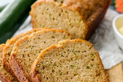 Close-up of moist, tender slices of single-loaf zucchini bread showing flecks of fresh zucchini, perfect for breakfast or snacking.