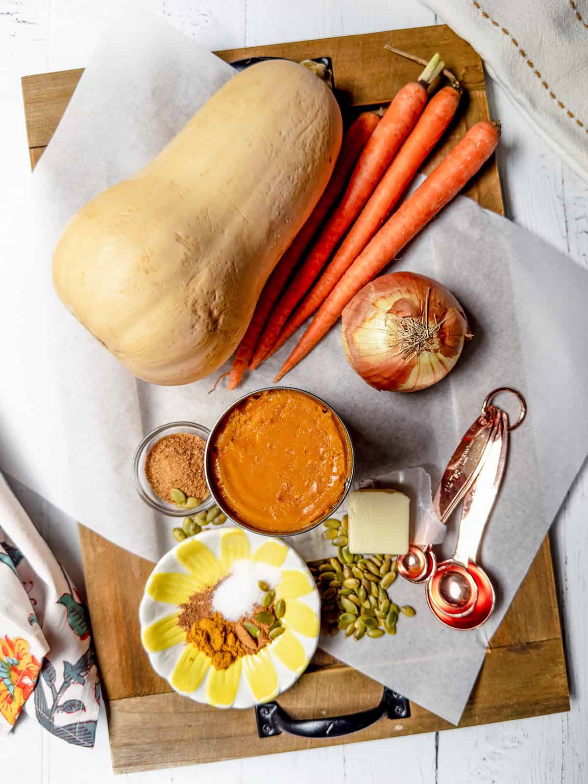 Butternut squash, carrots, onion, pumpkin puree, spices, apple cider, and other ingredients for autumn squash soup.