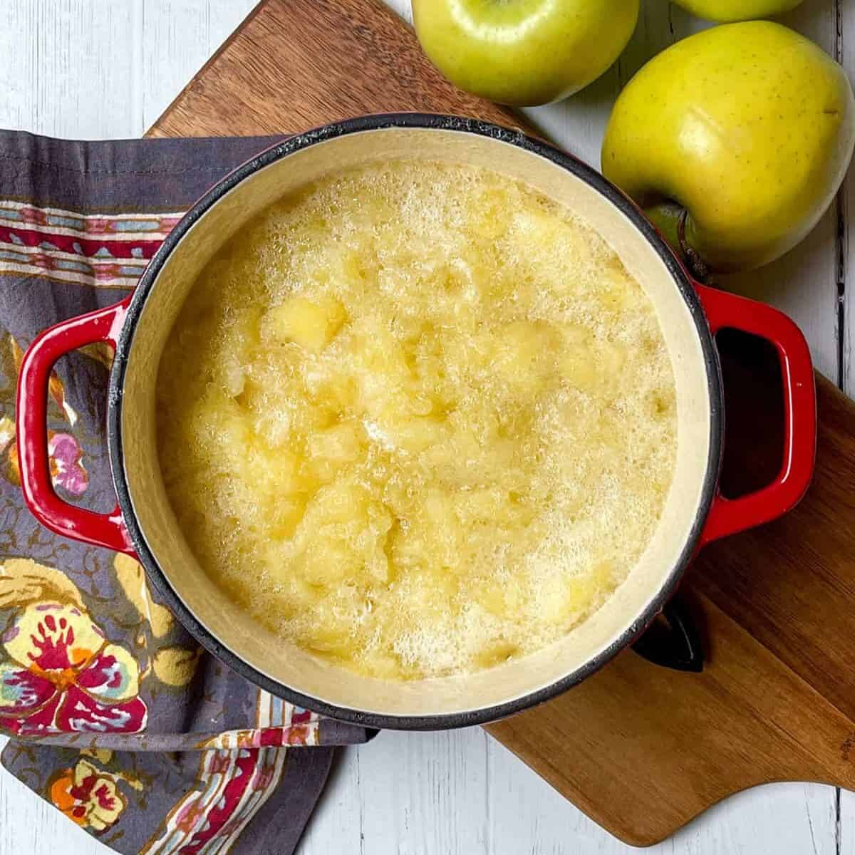 Cooked chunky apples in a large pot.