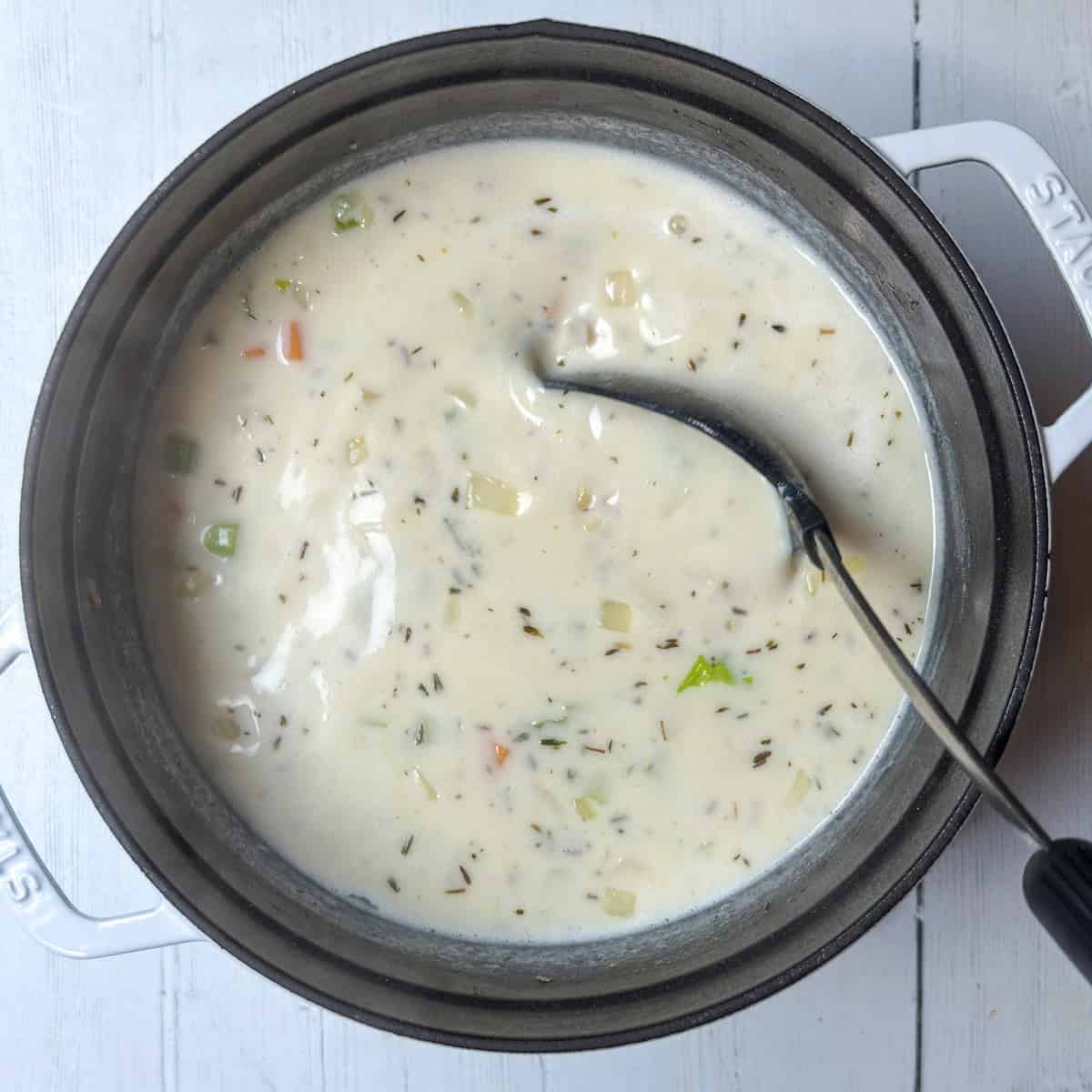 Cooking potato chowder in a large soup pot.
