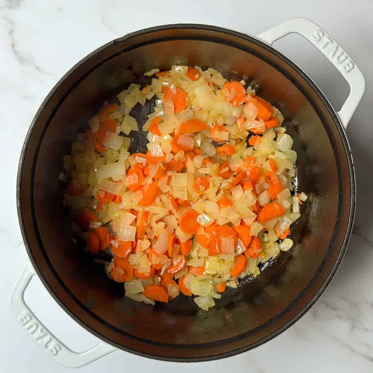 Sauteed carrots and onions in a large soup pot.