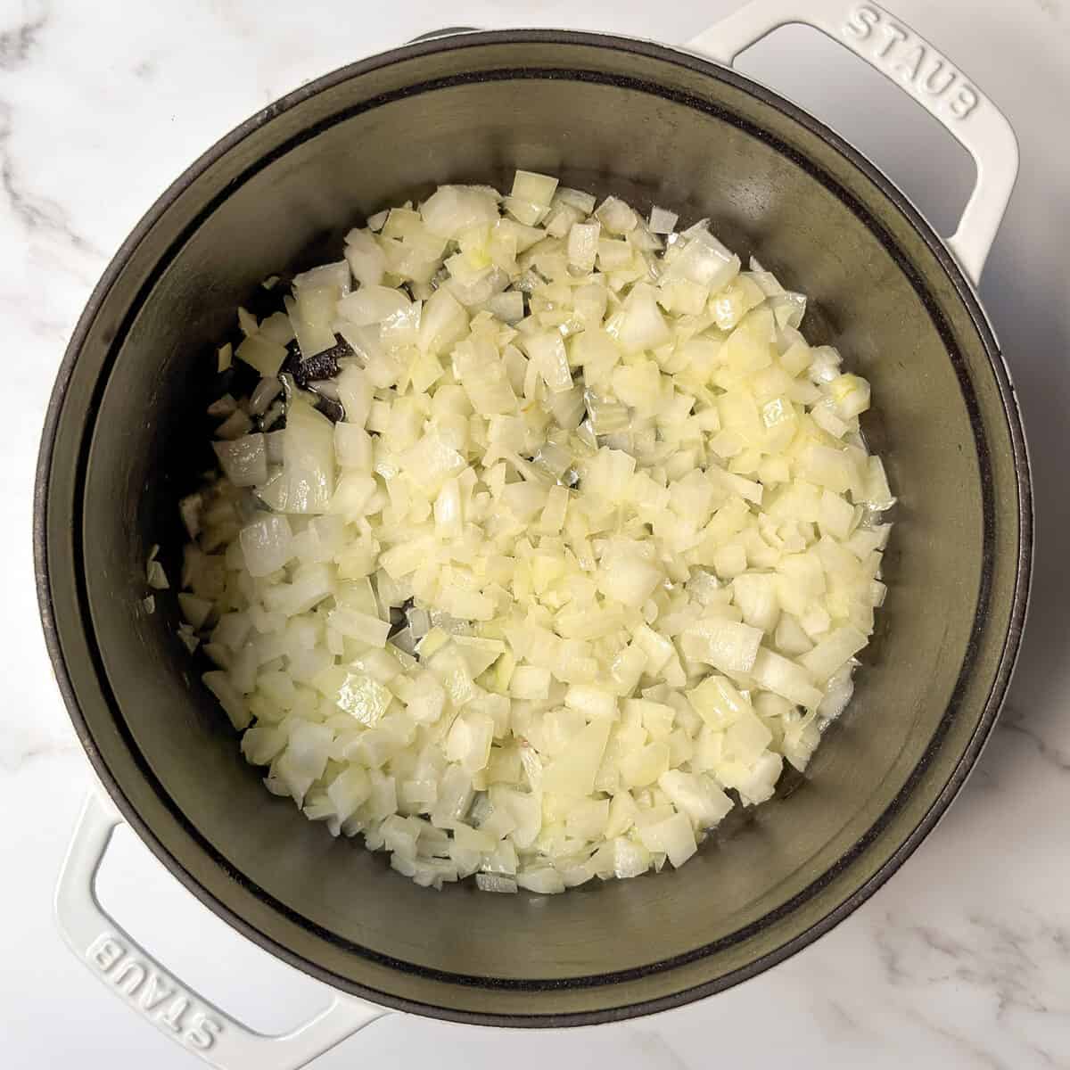 Saut&eacute;ed onions in a large soup pot.