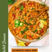 Southwest Ground Turkey Butternut Squash Skillet cooked in one pan with ground turkey, black beans, tomatoes, baby kale, and melted cheese. Garnished with lime wedges, jalapeños, and cilantro for a 30-minute dinner.