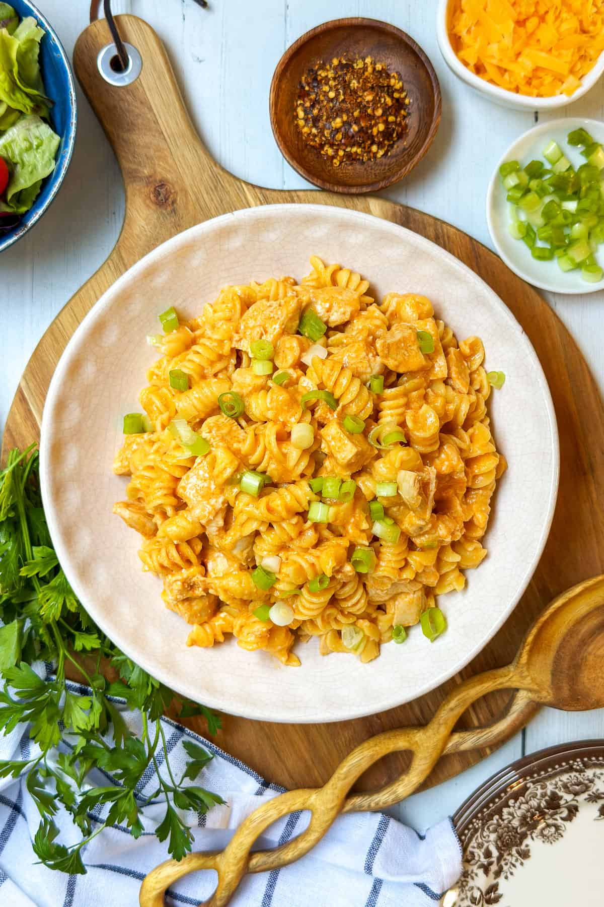 Bowl of Crockpot Buffalo Chicken Mac and Cheese garnished with green onions.
