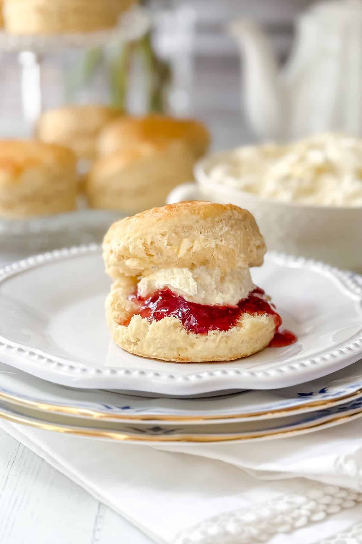 Classic English scone served with clotted cream and strawberry jam for afternoon tea.