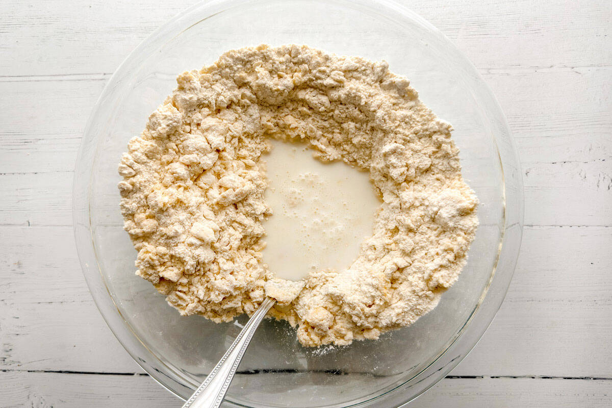 Adding milk to flour and egg mixture for scone dough.