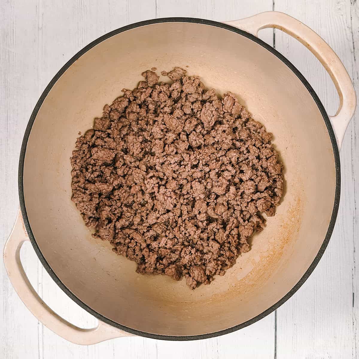 Browning lamb in a large soup pot.