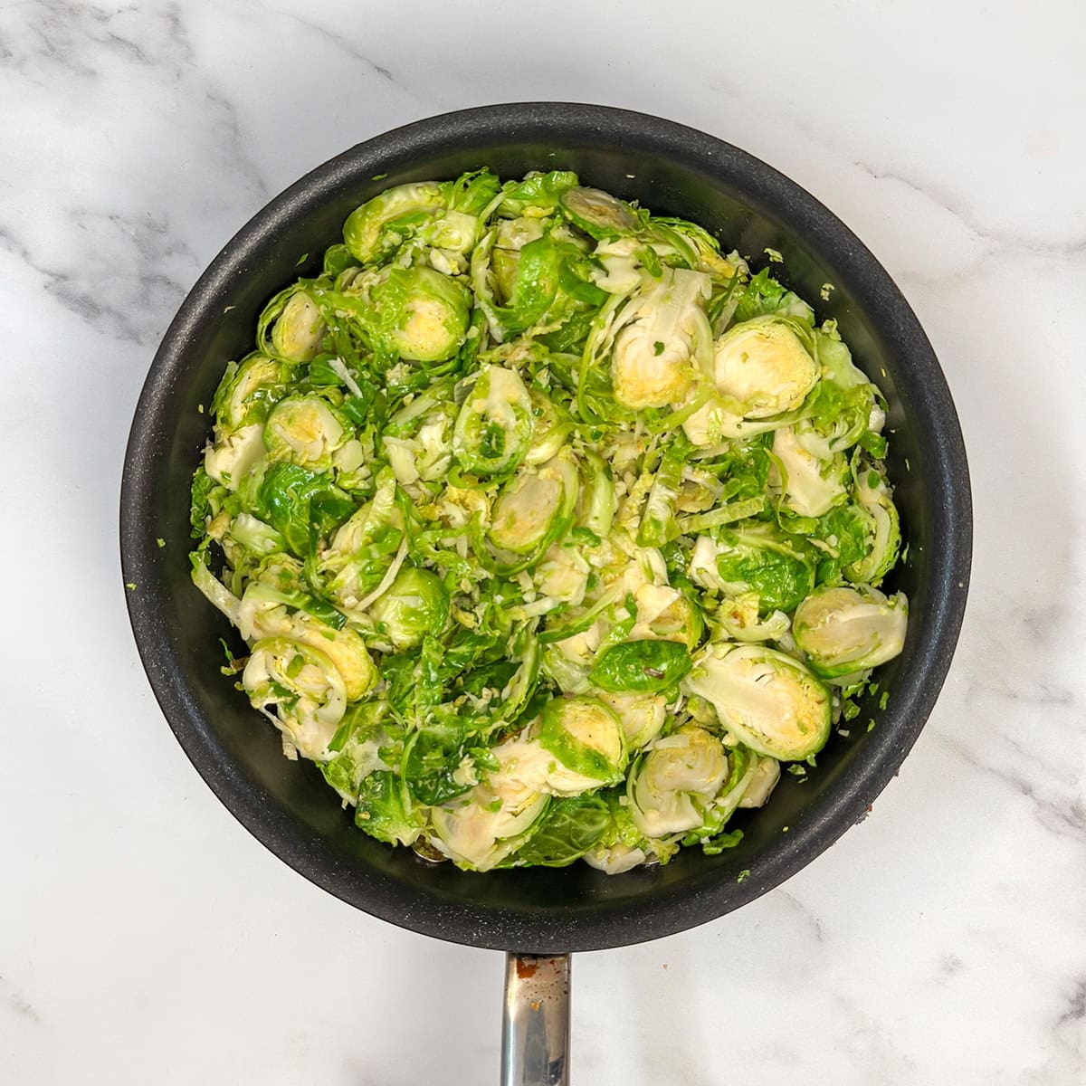 Saut&eacute;ing Brussels Sprouts in a nonstick skillet.