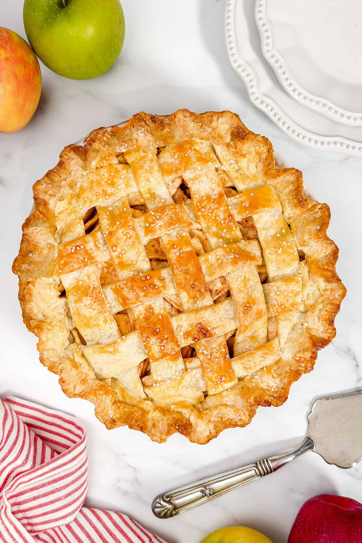 Baked apple pie recipe cooling on the counter.