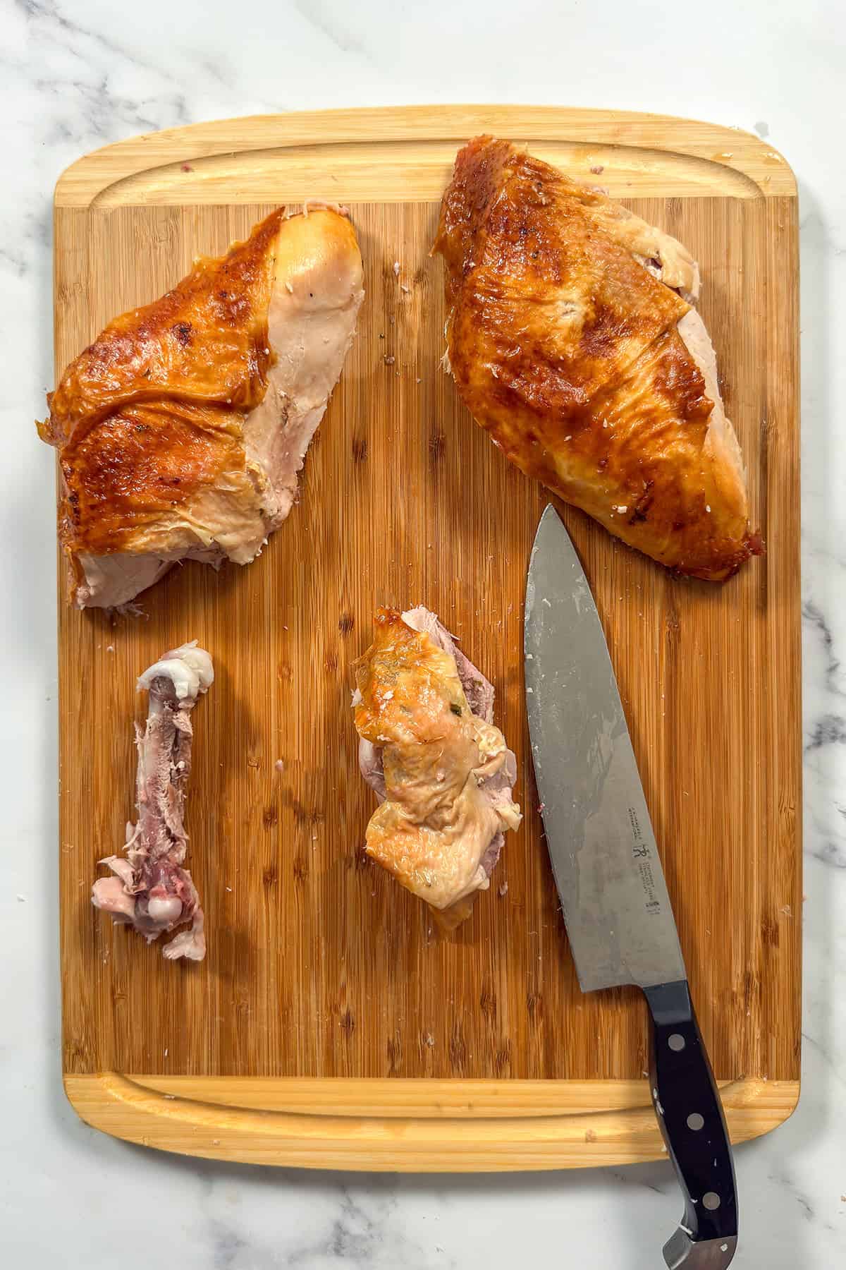 Preparing to slice turkey thigh meat after removing bone.