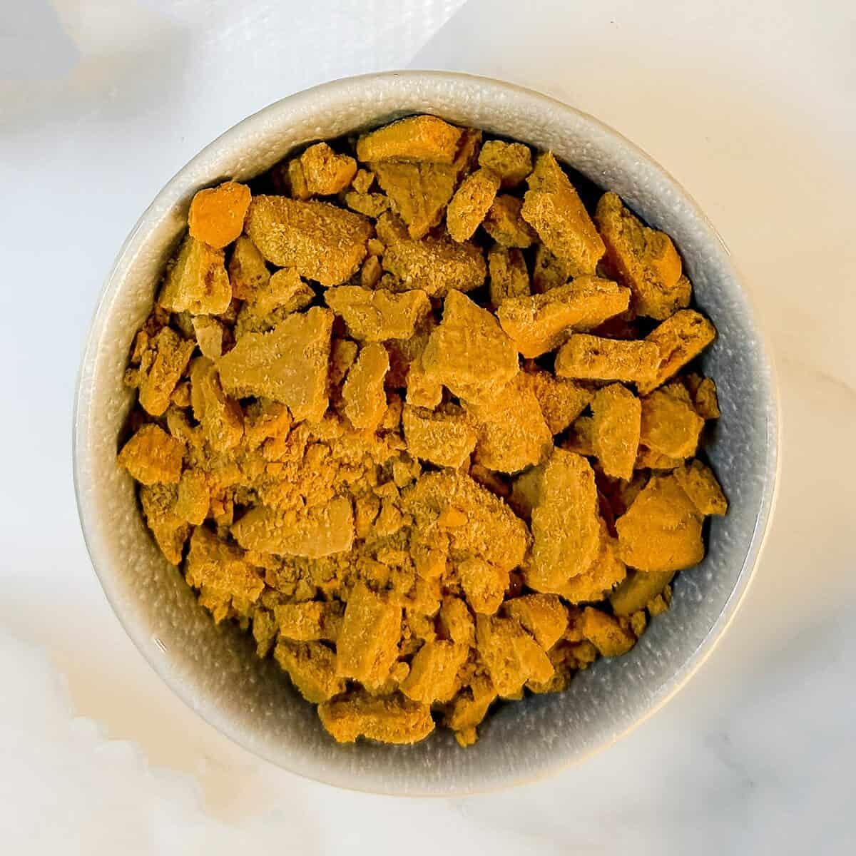 Crumbed gingersnap cookies in a bowl ready for layering the pumpkin trifle.