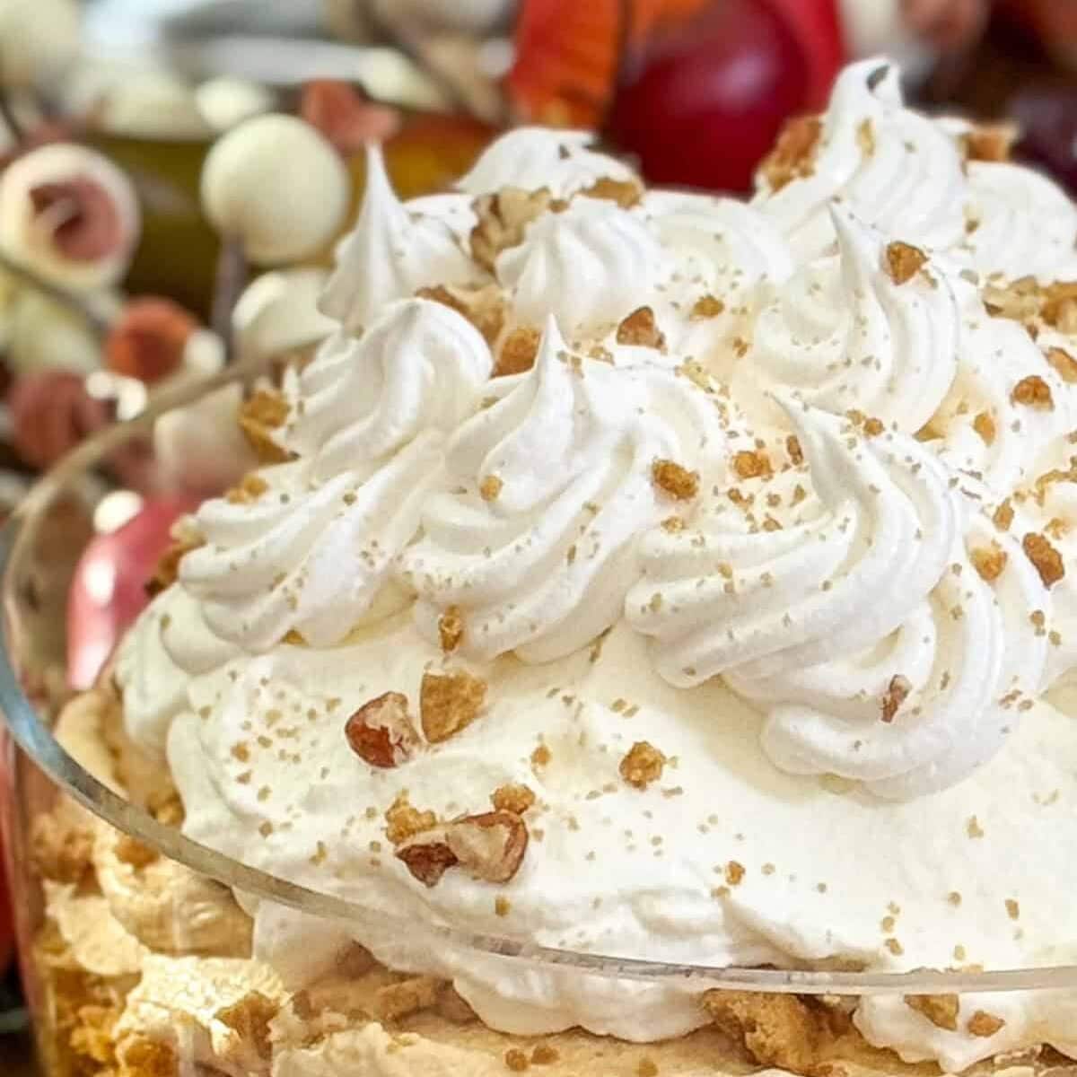 Closeup view of plain Chantilly Cream, piped onto the top of the pumpkin trifle for garnish.