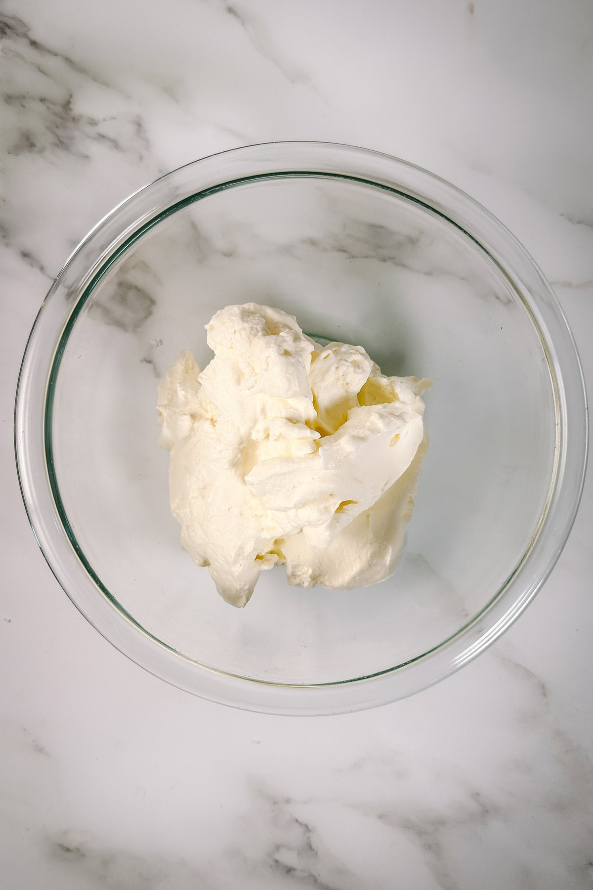 Bowl of freshly whipped cream ready for assembling Santa Hat Brownie Bites.