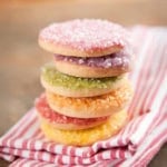 Stack of vanilla bean icebox cookies with pastel colored sprinkles on top.
