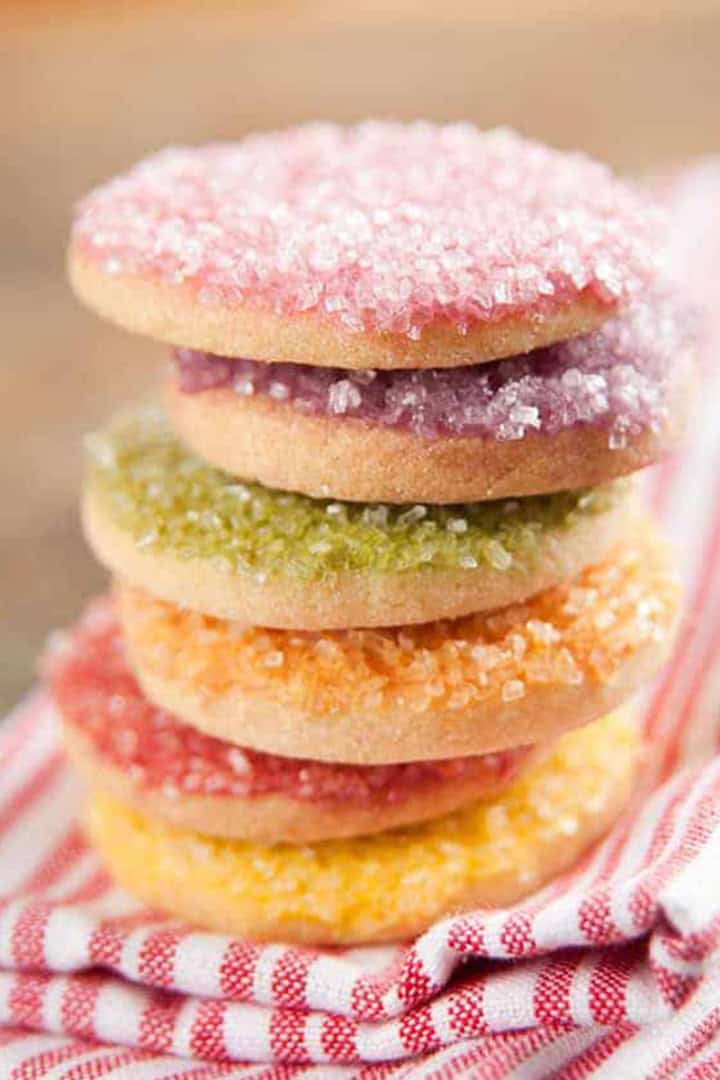 Stack of vanilla bean icebox cookies with pastel colored sprinkles on top.