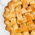 Square image of all butter pie crust baked into a lattice top pie with golden, sugar crusted top.