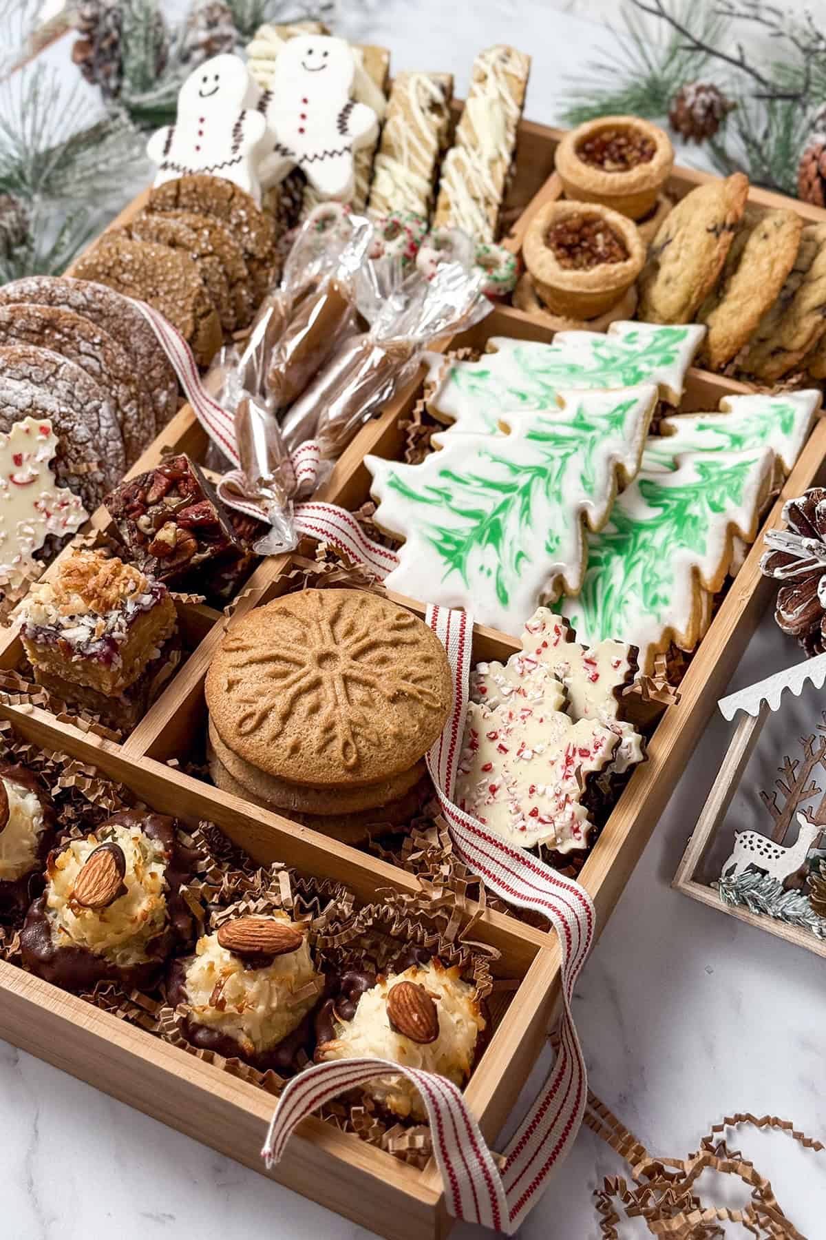 Closeup view of Woodland Christmas Box cookies featuring sugar cookies, specaloos, pecan tassies, brownies, and more.