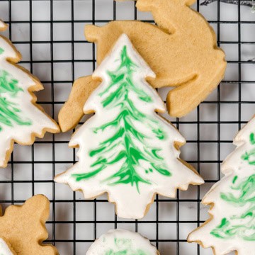 Square closeup view of sugar cookie dipped in royal icing in the shape of a Christmas tree.