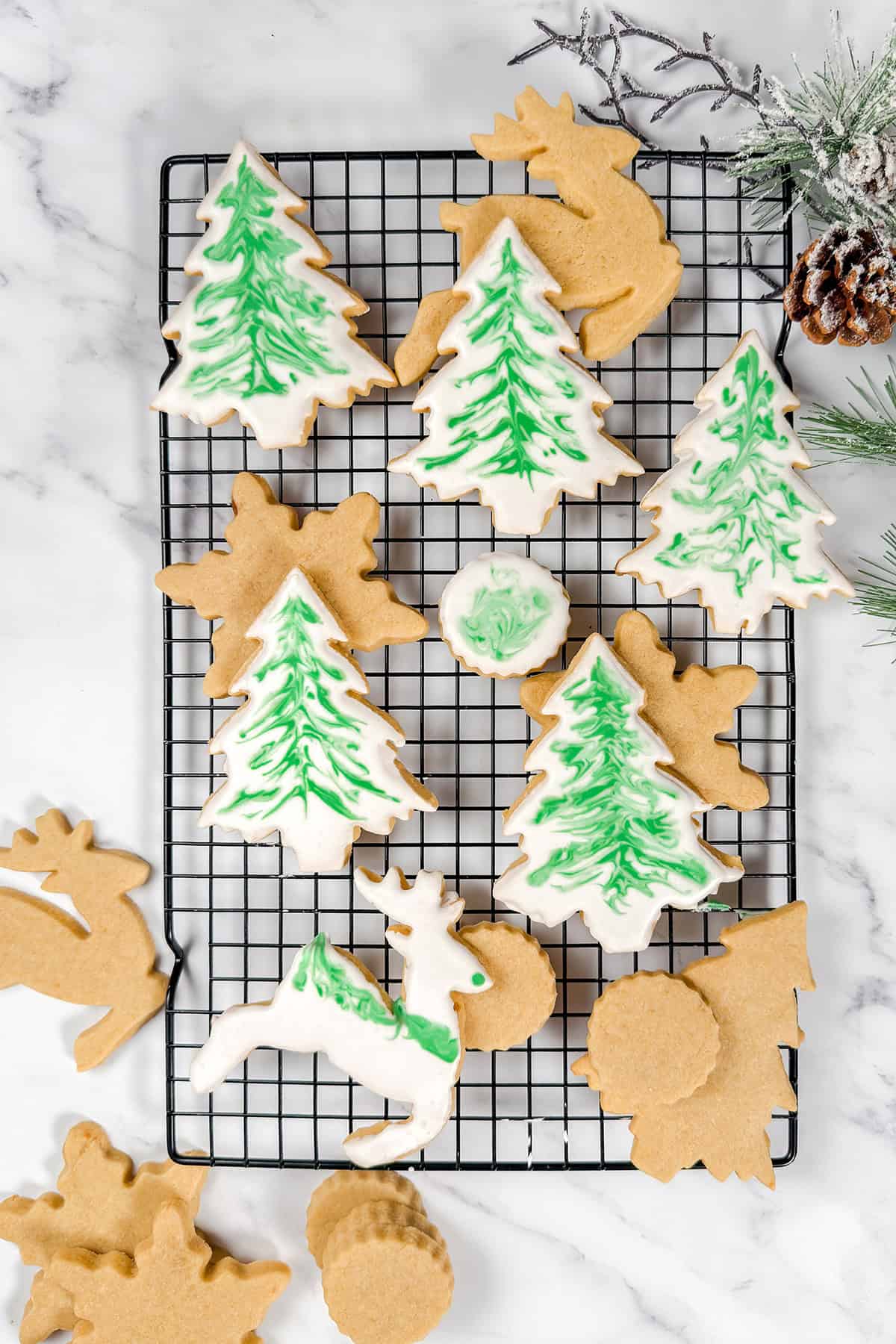 Swirled and decorated sugar cookies with royal icing on a black grid.