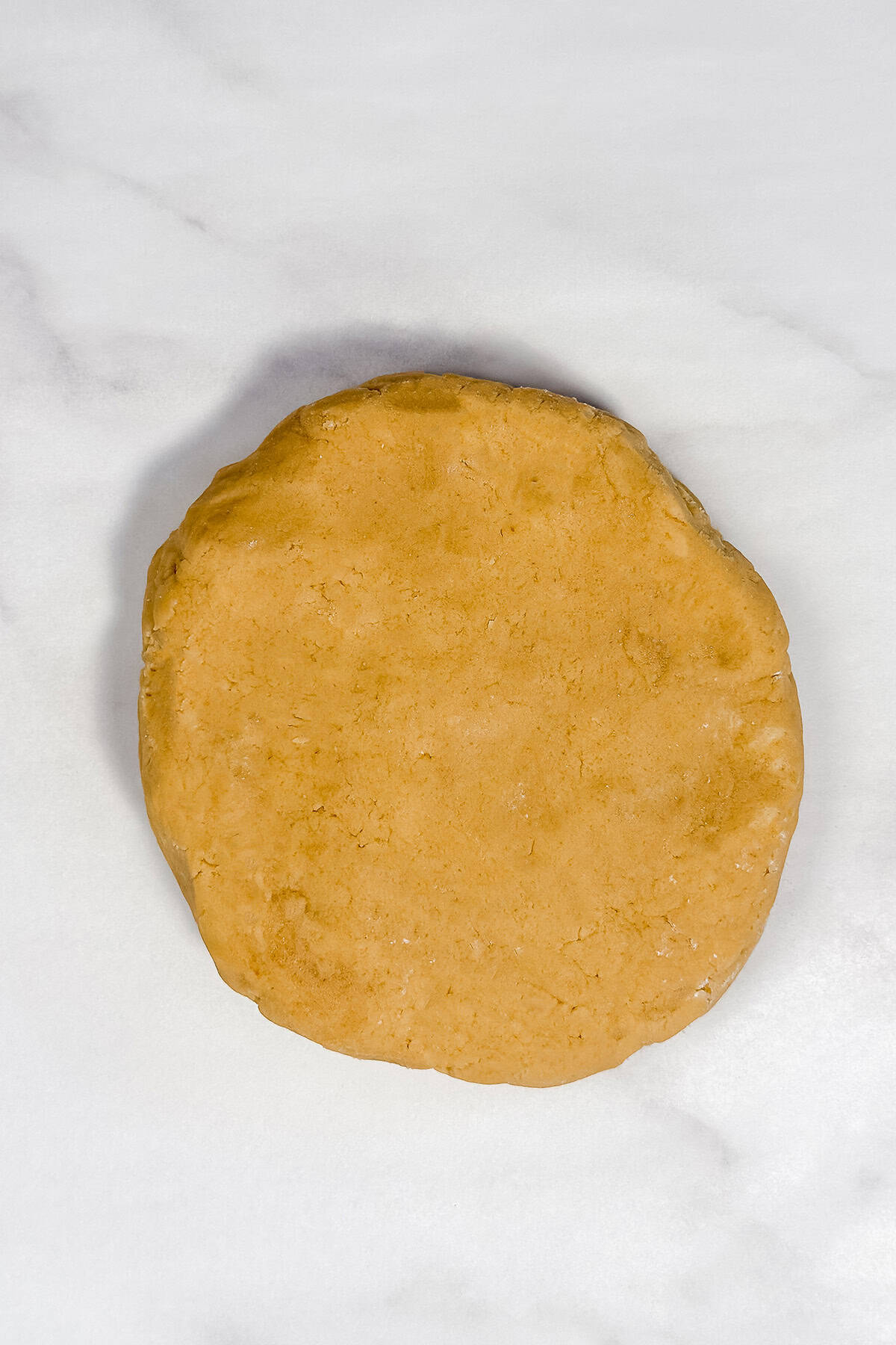 Brown sugar cookie dough ready for rolling on a marble surface.