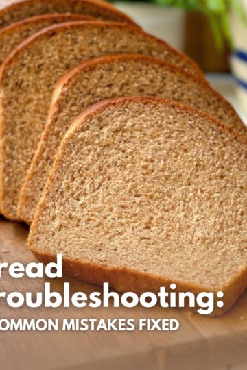 A sliced loaf of homemade whole wheat bread showing perfect internal texture for a troubleshooting guide.
