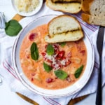 Homemade tomato potato soup served warm with bread and Parmesan.