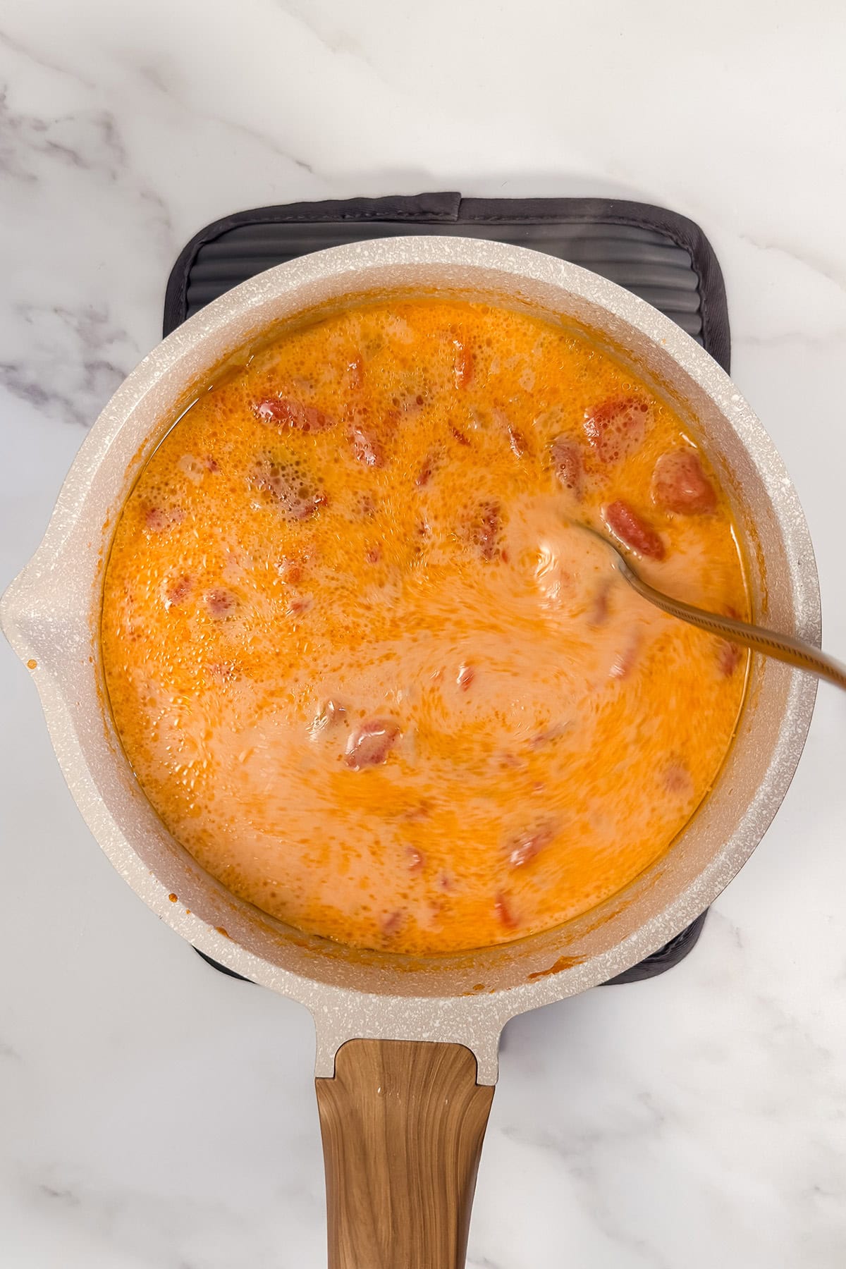 Evaporated milk stirred into tomato potato soup until creamy.