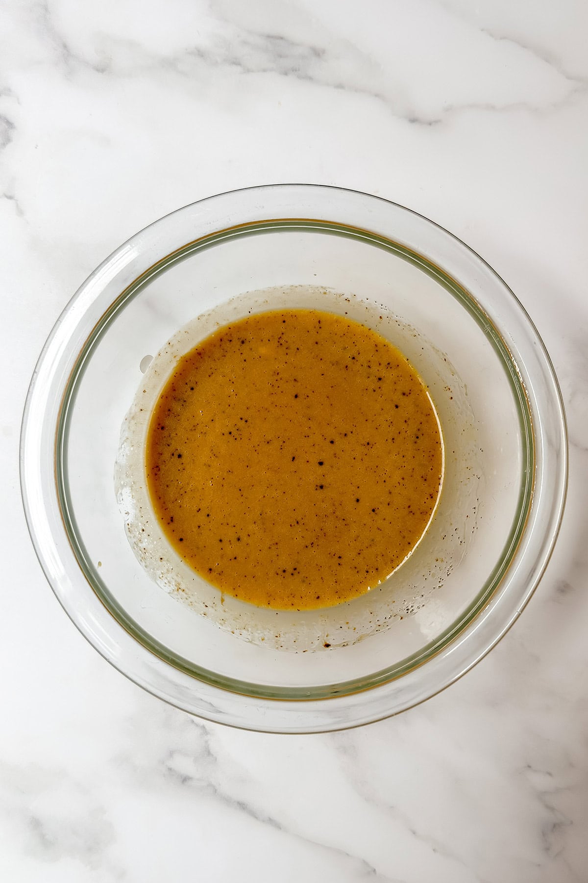 Whisking brown sugar, cream, egg yolk, and vanilla for mini chocolate cake batter