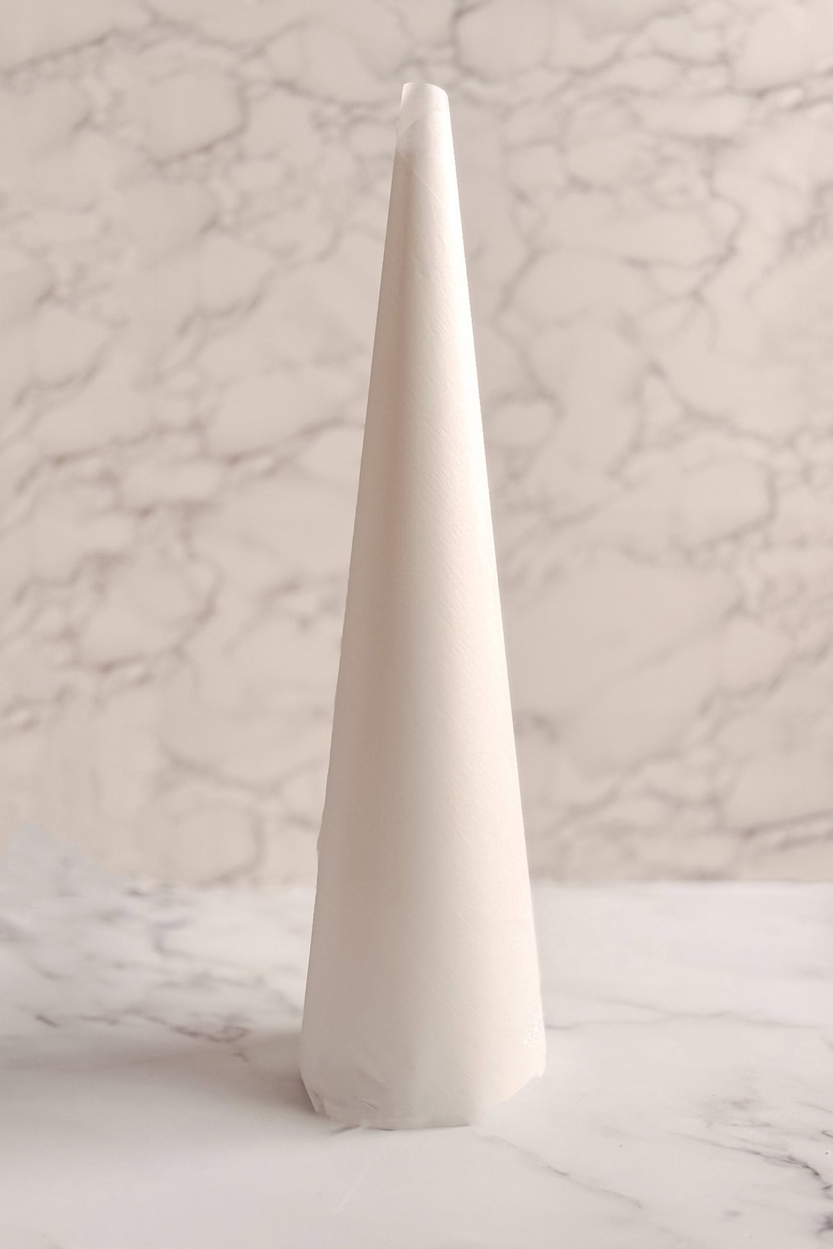 Parchment-wrapped styrofoam cone for making a bonbon tree.