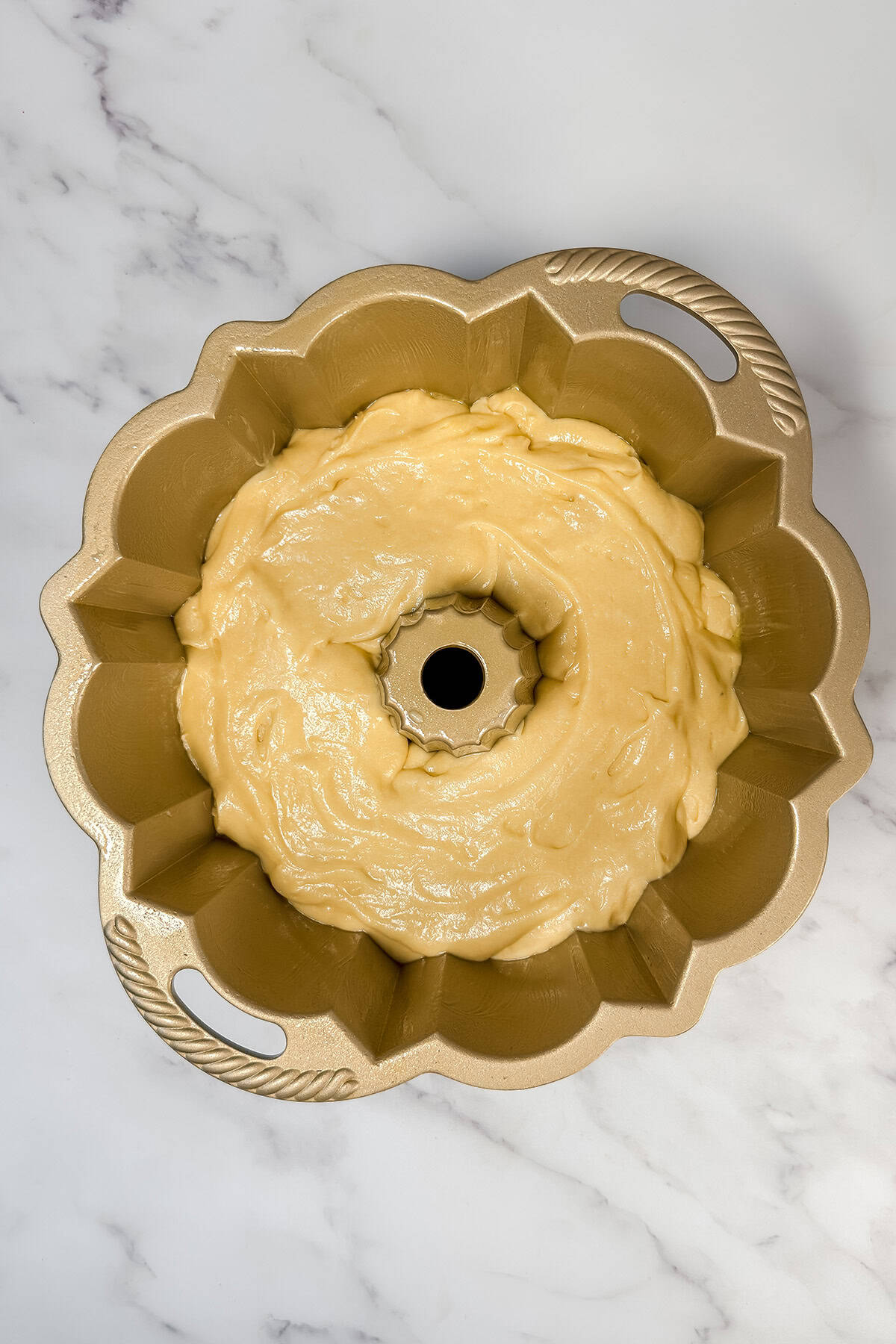Bundt cake pan filled with unbaked Kentucky Butter Cake batter ready for the oven.