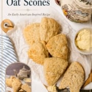 A plate of Colonial Scones arranged on a white cloth, with a knife, butter, and a floral teapot beside them; "Colonial Oat Scones" text appears at the top—perfect for your next Tea Table gathering.