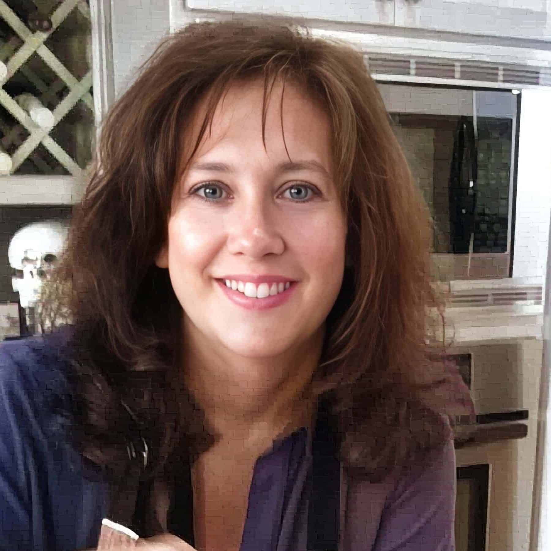 Stephanie Wilson, founder of 31Daily in an apron stirring a pot of strawberry jam on a kitchen counter, with a large covered pot next to her and appliances in the background-capturing the warmth of 31 Daily home cooking.