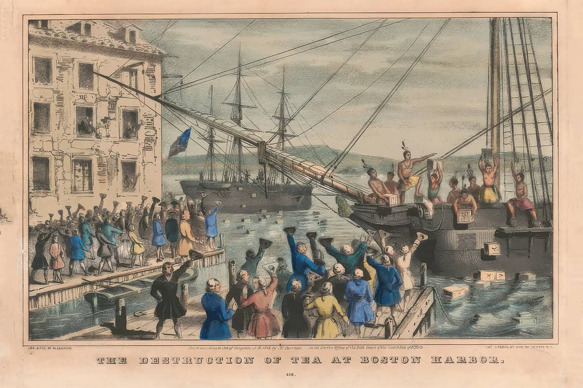 Colonists, some dressed as Indigenous people, throw crates filled with different types of tea off a ship into Boston Harbor during the Boston Tea Party, while a crowd watches from the dock; sails and a large building are visible.