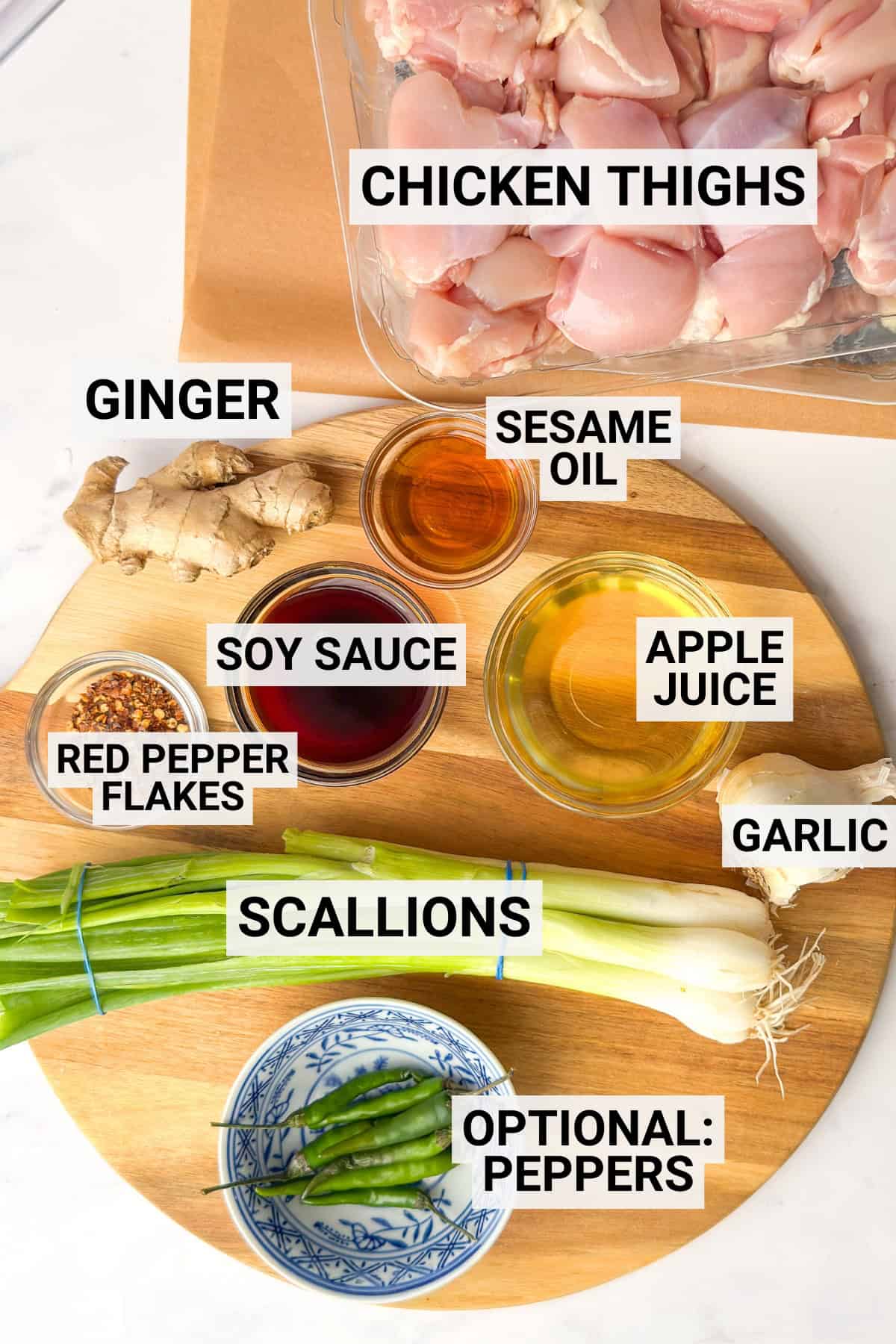 Ingredients for Three Cup Chicken, including chicken thighs, ginger, garlic, scallions, basil, soy sauce, apple juice, sesame oil, and red pepper.