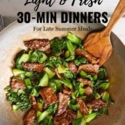 A wok filled with cooked beef strips and bok choy, with a wooden spatula resting inside. Text: "Light & Fresh Healthy 20 Minute Dinners Meal Plan for Late Summer Meals. 31Daily.com.