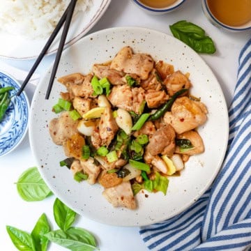 Top view of three cup chicken with scallions, chicken, garlic, and red pepper flakes.