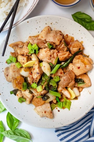 Top view of three cup chicken with scallions, chicken, garlic, and red pepper flakes.