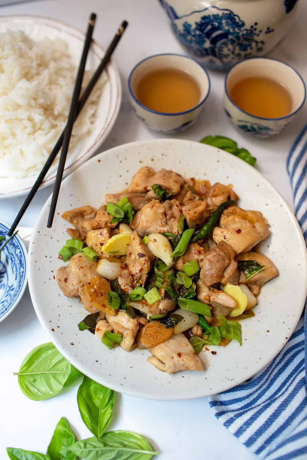 Three Cup Chicken with ginger, garlic, scallions, basil, and chile served with white rice.