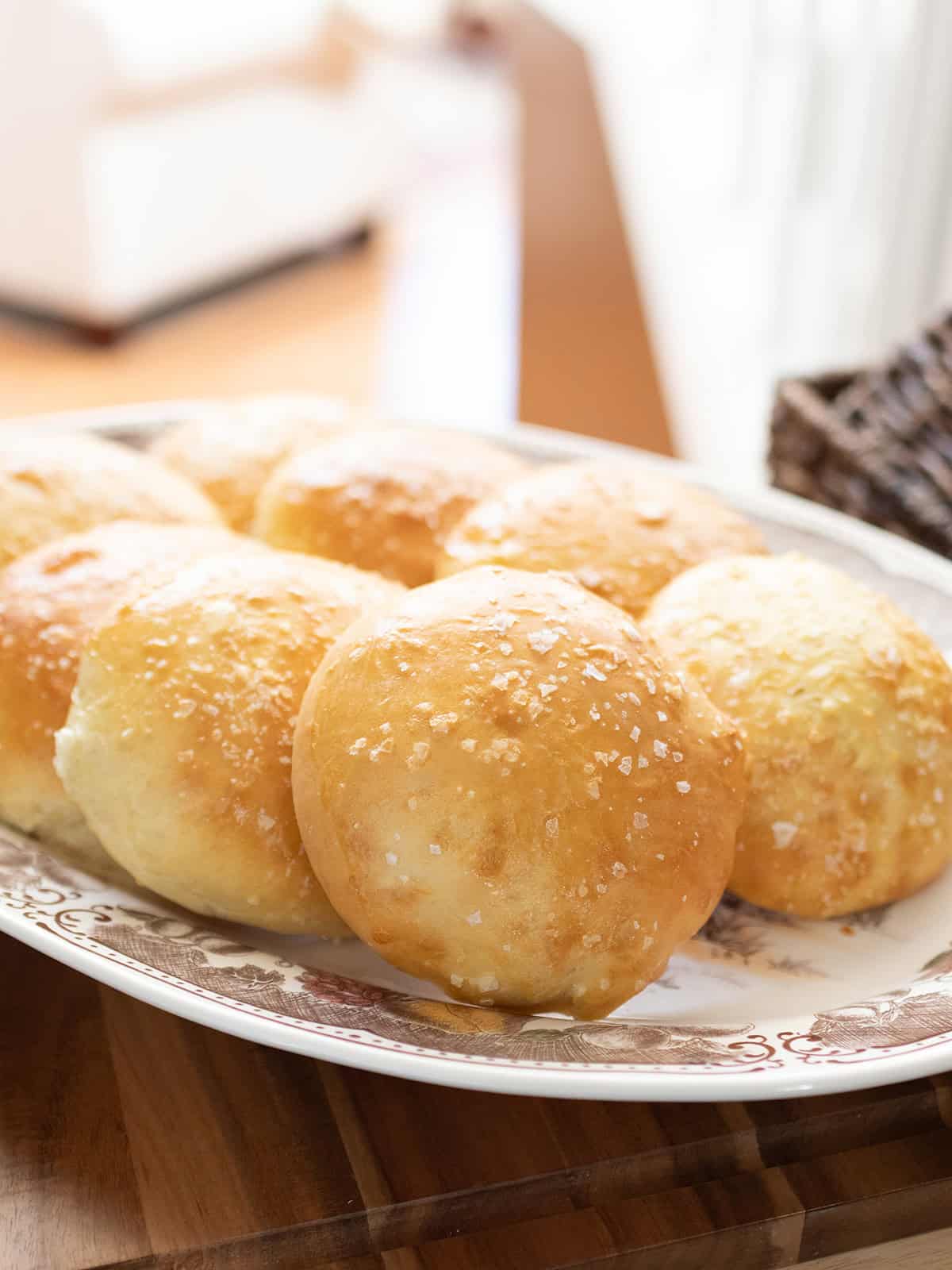 Soft golden homemade hamburger buns topped with coarse sea salt.