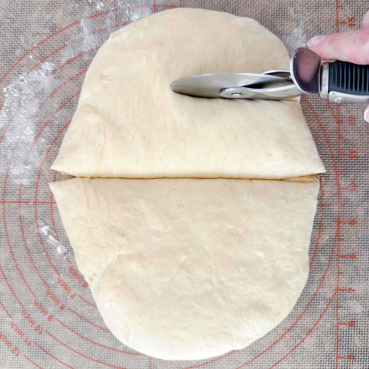 Hamburger bun dough being divided into eight equal pieces.